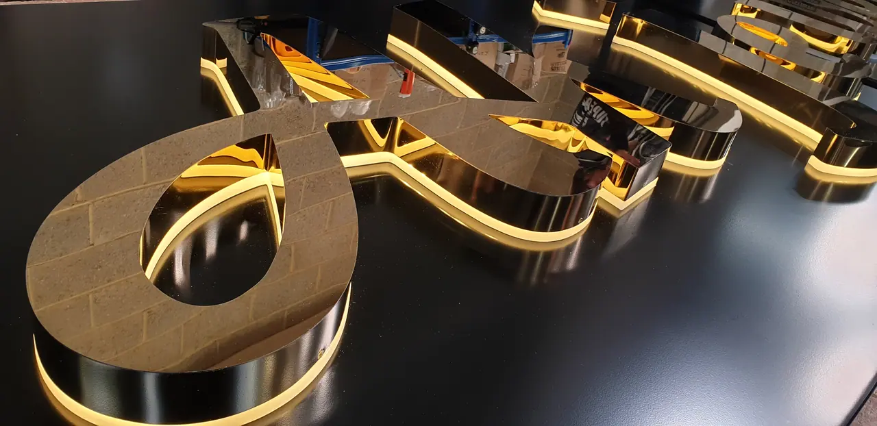 Gold mirror 3D letters with warm back-lighting