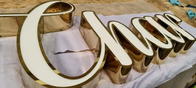Gold script 3D letters with white edges