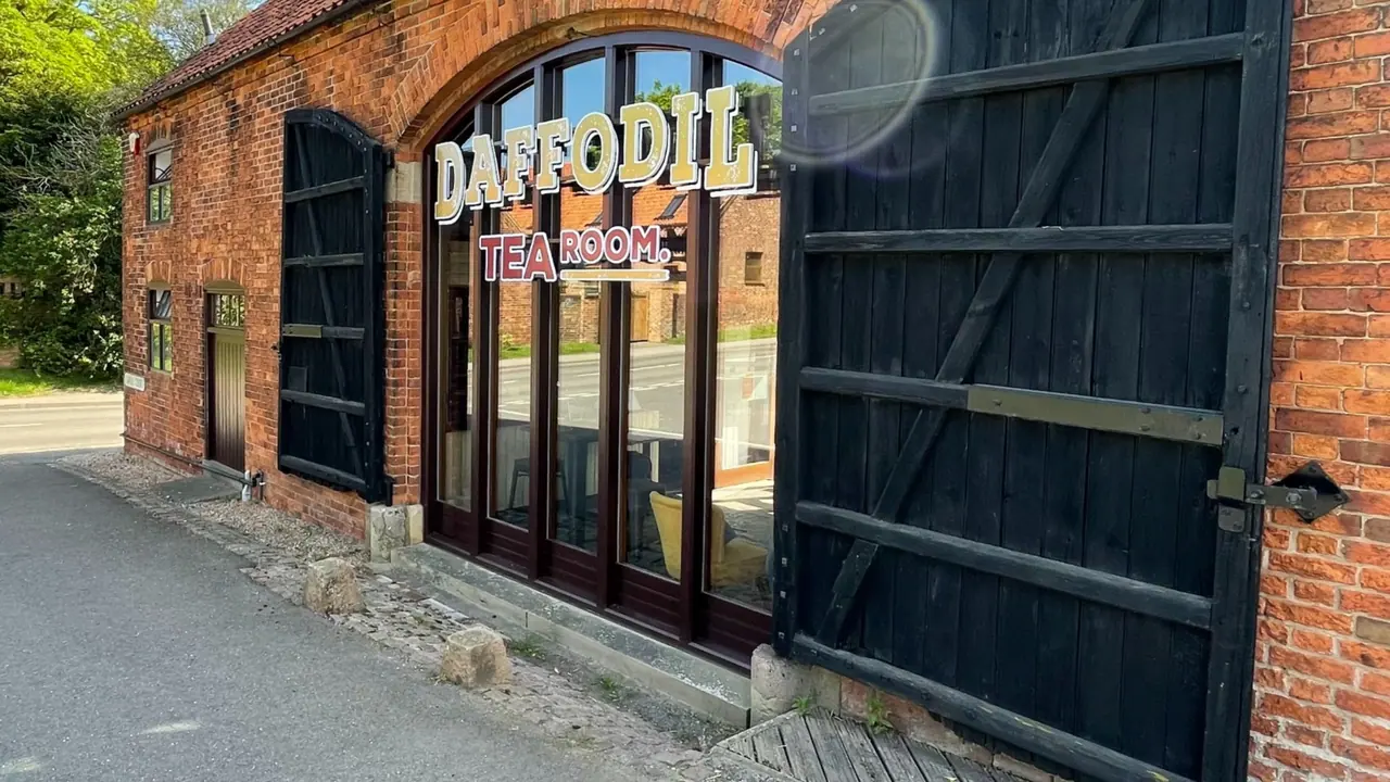Illuminated lettering above the arched windows of a tea room