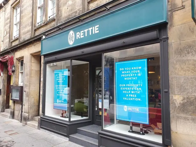 Teal shop front fascia with window graphics